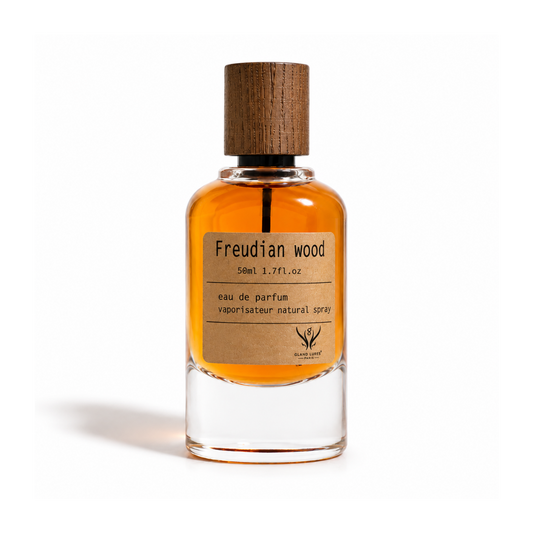 A 50ml glass bottle of Freudian Wood Eau de Parfum with amber-colored liquid, a brown wood-grain cap, and a brown kraft paper label, shown on a white background.