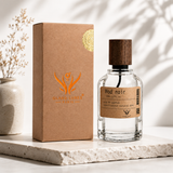 A clear glass perfume bottle with a dark wood cap stands beside its brown kraft box. The box has an orange logo reading GLAND LURES PARIS, and the bottle label reads Mod noir.