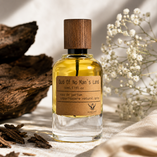 A 50ml bottle of 'Oud Of No Man's Land' natural perfume spray by Black Lotus Fragrance. The clear glass bottle is filled with golden-yellow liquid and features a dark brown wooden cap and a kraft paper label.